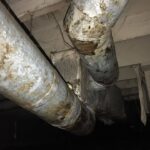 Rusty pipes in basement